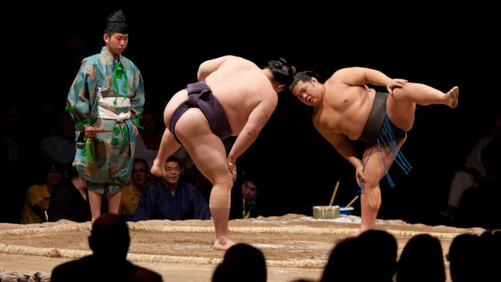 Sumo rikishi prepare to begin a bout at a basho in Japan
