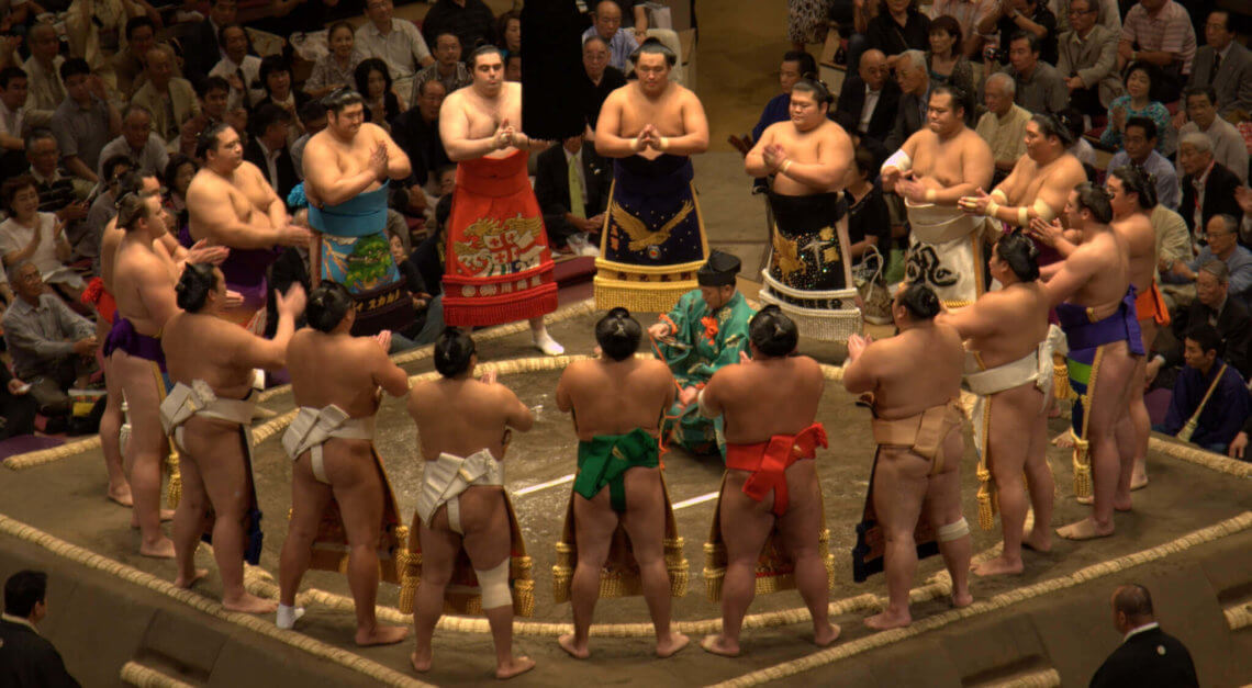 Sumo (rikishi) gathering around the ring (dohyo) before a tournament (basho)