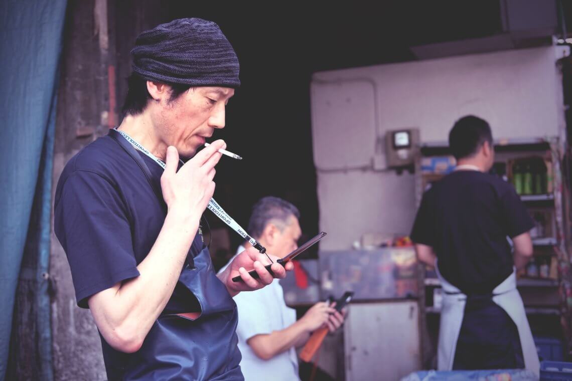 Tsukiji worker taking a cigarette break, at Tsukiji Market in Tokyo, Japan