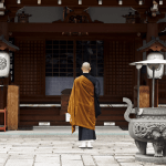 Buddhist monk in front of temple in Kyoto, Japan