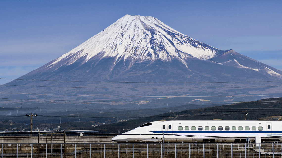 Shinkansen (bullet train) passing Mount Fuji, Japan