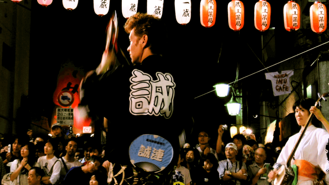 A Japanese performer dances with fans at the Awa Odori Festival, Koenji, Tokyo, Japan.